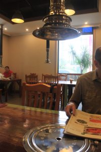 Retractable chimney over BBQ pit